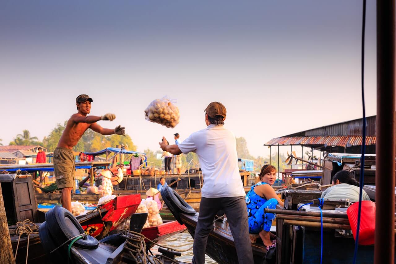 Photo of person throwing a bag to another person